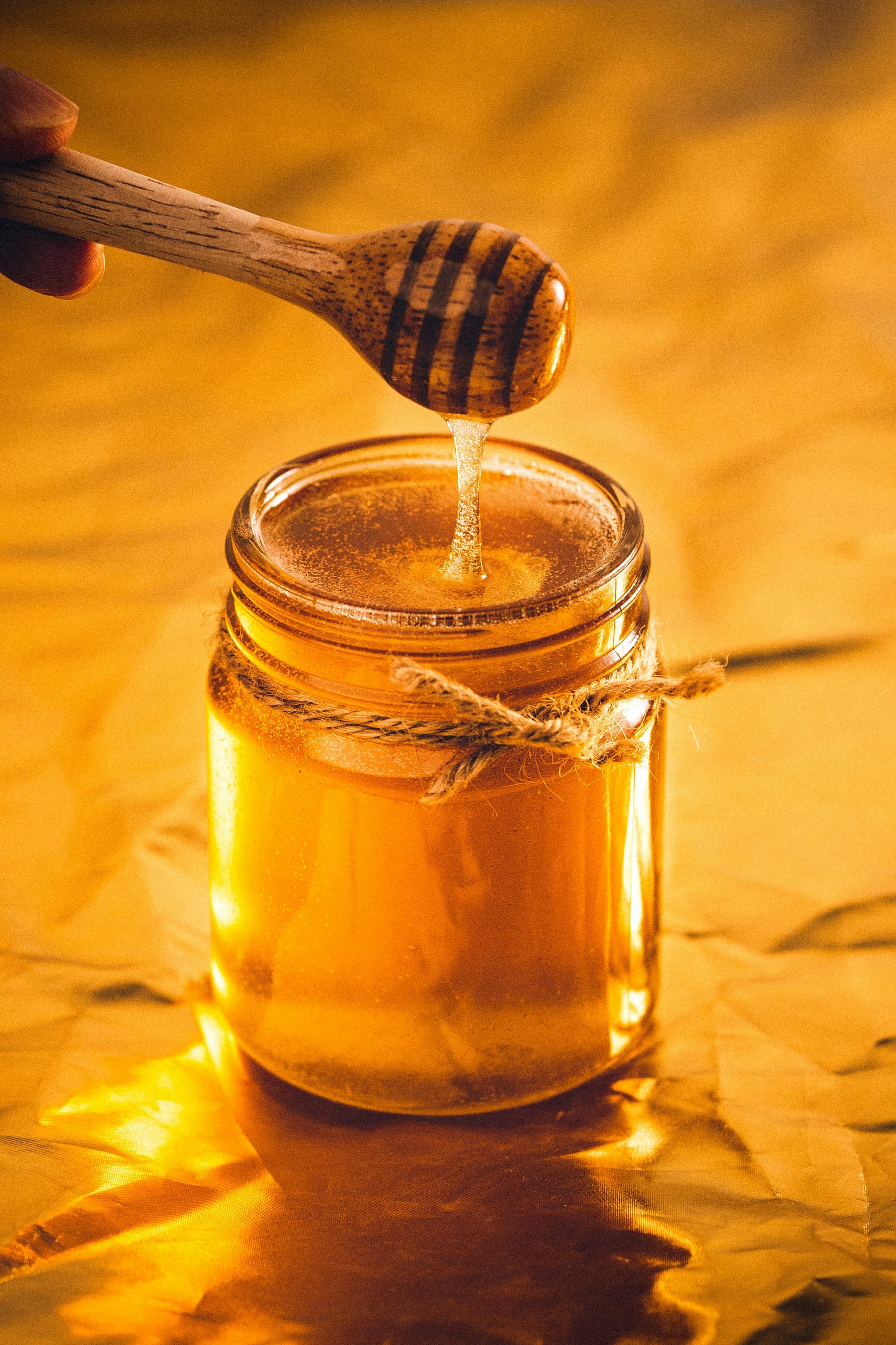 Beekeeper inspecting honeycomb frames from a beehive